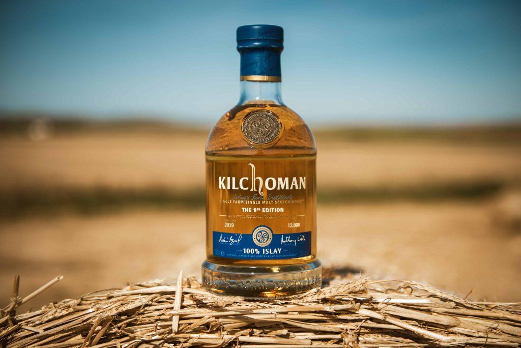 Kilchoman 100 % Islay Edition bottle in a wheat field